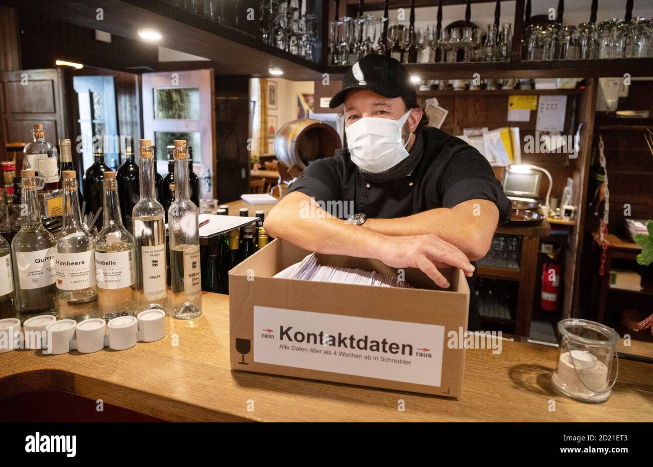 Stuttgart, Germany. 06th Oct, 2020. Markus Knörzer, owner of the restaurant 'Brauerei Wirtshaus Sanwald', leans on a cardboard box with filled out sheets for contact tracing in restaurants according to the Corona regulation. In a press conference, Baden-Württemberg's Minister of Health, Lucha, emphasised the importance of tracing infection chains. Therefore, the proper completion of the tracing sheets in restaurants and pubs is increasingly controlled. (to dpa 'Baden-Wuerttemberg raises alarm - tightened corona controls') Credit: Marijan Murat/dpa/Alamy Live News Stock Photo