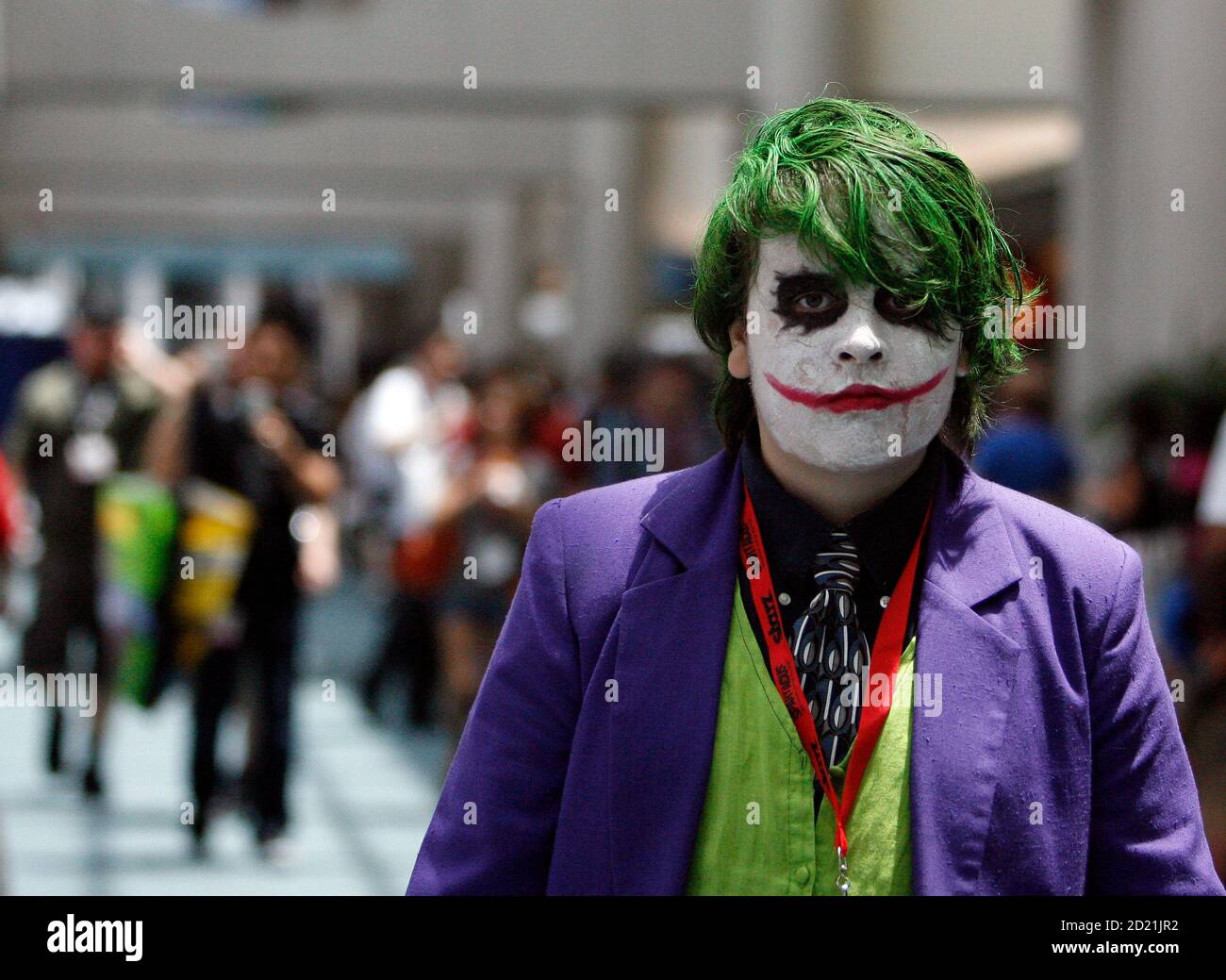 A visitor dressed like the Joker character from the movie 'The Dark Knight' walks during the 40th annual Comic Con Convention in San Diego July 23, 2009.  The convention runs July 23-26.  REUTERS/Mario Anzuoni   (UNITED STATES ENTERTAINMENT) Stock Photo