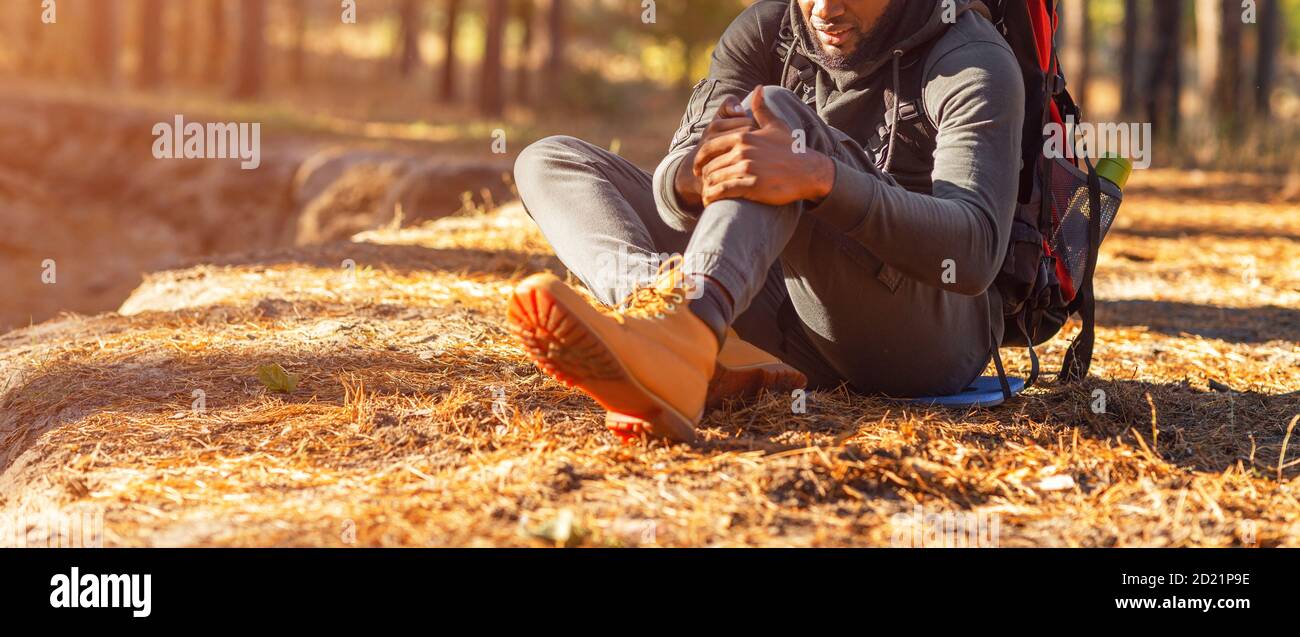 Cropped of black man rubbing his injured knee Stock Photo Alamy