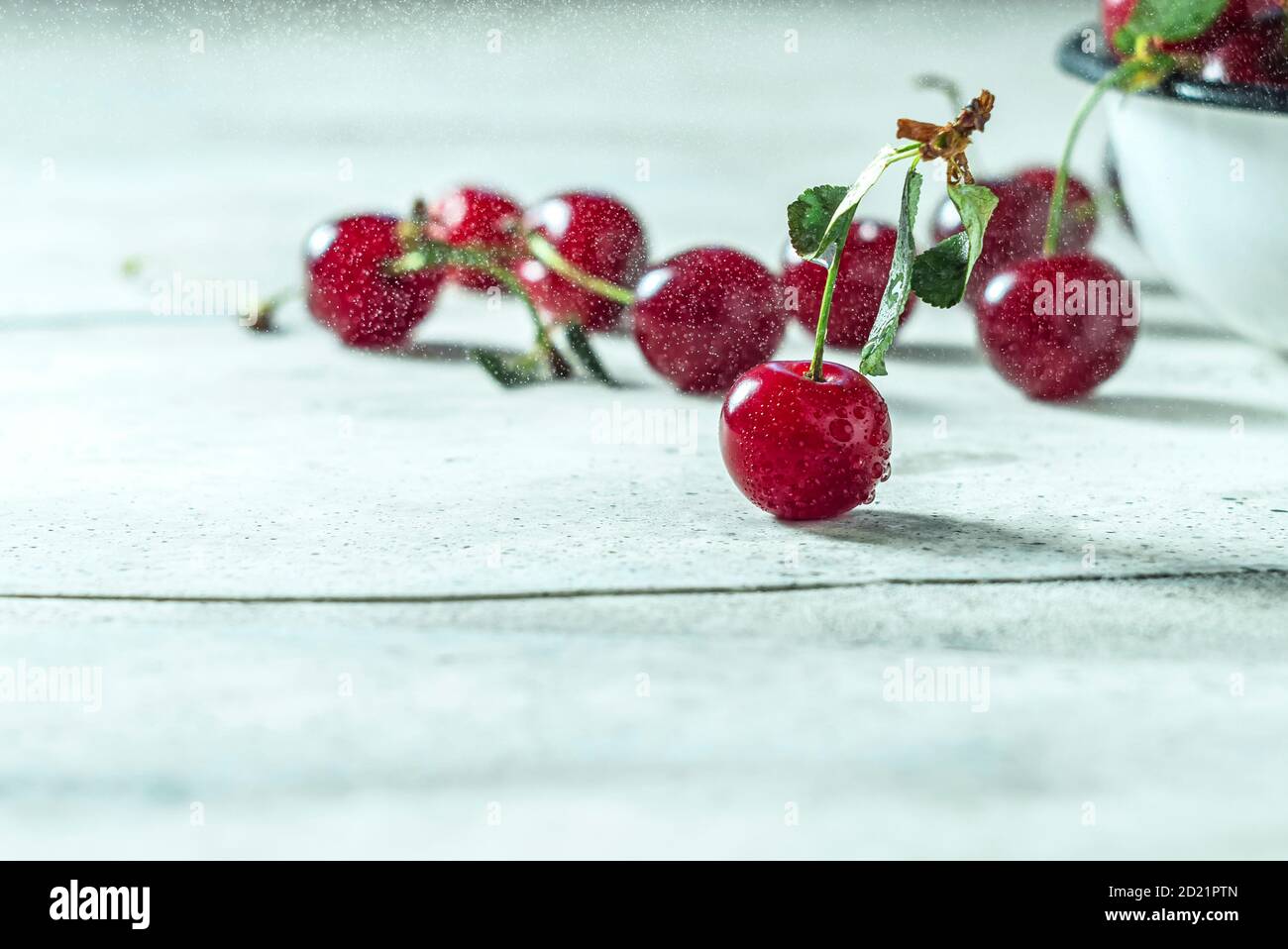 Close up image of sweet cherry on a light concrete background. Stock Photo