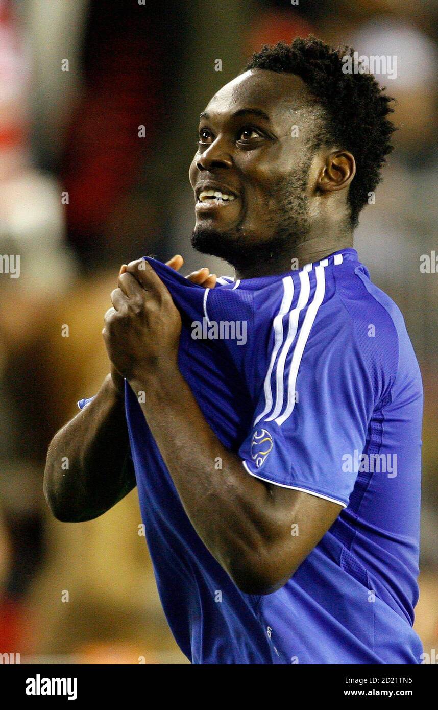 Michael Essien holds out the badge 