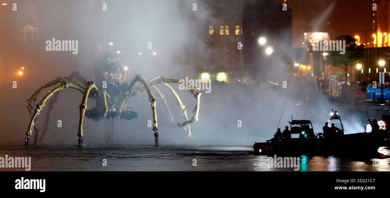 A giant mechanical spider, part of a piece of 'free theatre' by French company La Machine entitled 'Les Mecaniques Servants', is lowered into Liverpool's Salthouse Dock, September 5, 2008. The 37 tonne spider which stands at 50 feet (15 metres) tall is in Liverpool as part of the city's European capital of culture celebrations. REUTERS/Phil Noble (BRITAIN) Stock Photo