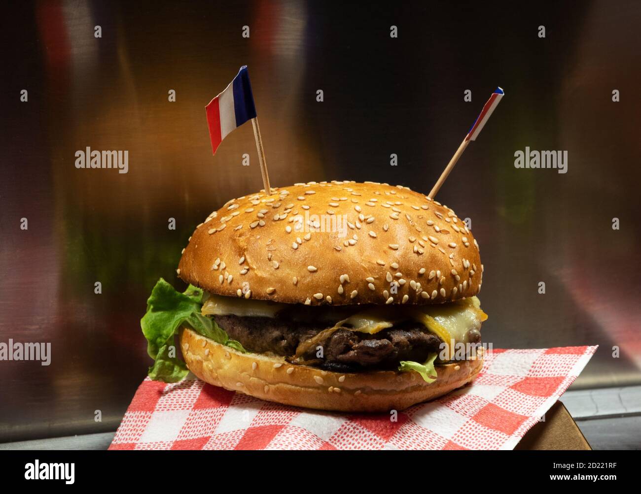 France street food. Fresh tasty burger with cheese and French flags at food track counter