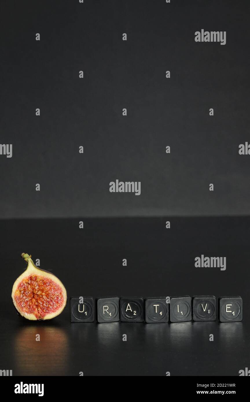 Idea Figurative made from Figs and Scrabble Tile Word on black table Stock Photo
