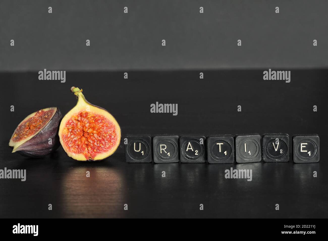 Idea Figurative made from Figs and Scrabble Tile Word on black table Stock Photo