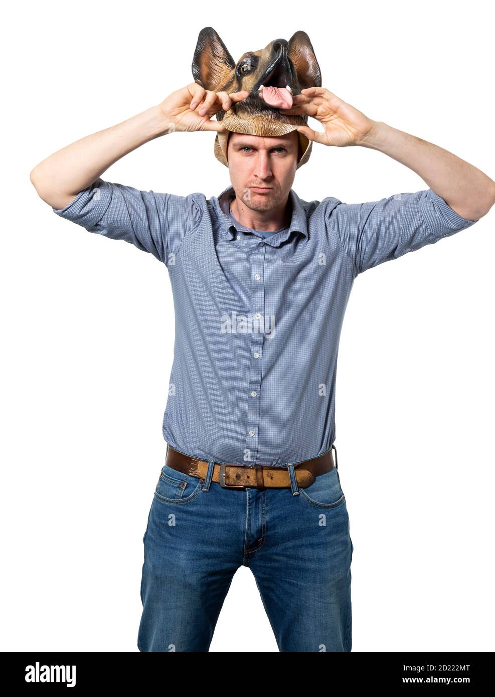 Caucasian man taking off dog mask with sulking facial expression. Medium shot. Isolated white background. Studio shot. Stock Photo