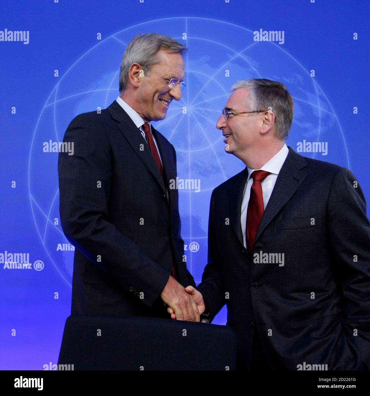 Michael Diekmann (L), CEO of Europe's biggest insurer Allianz SE, greets his Chief Financial Officer (CFO) Paul Achleitner before their company's annual news conference in Munich February 25, 2010. Allianz Group today reported solid results for fiscal year 2009, despite a challenging global economy. Based on preliminary figures, total revenues grew 5.2 percent to 97.4 billion euros for the year. REUTERS/Michaela Rehle (GERMANY) Stock Photo