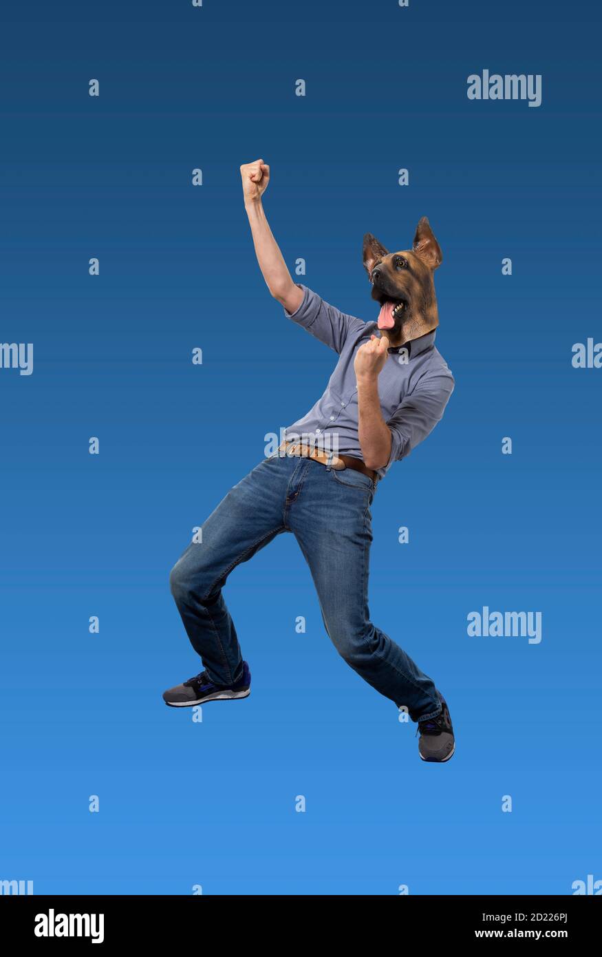 Man wearing dog mask in clenched fist celebration pose. Isolated blue