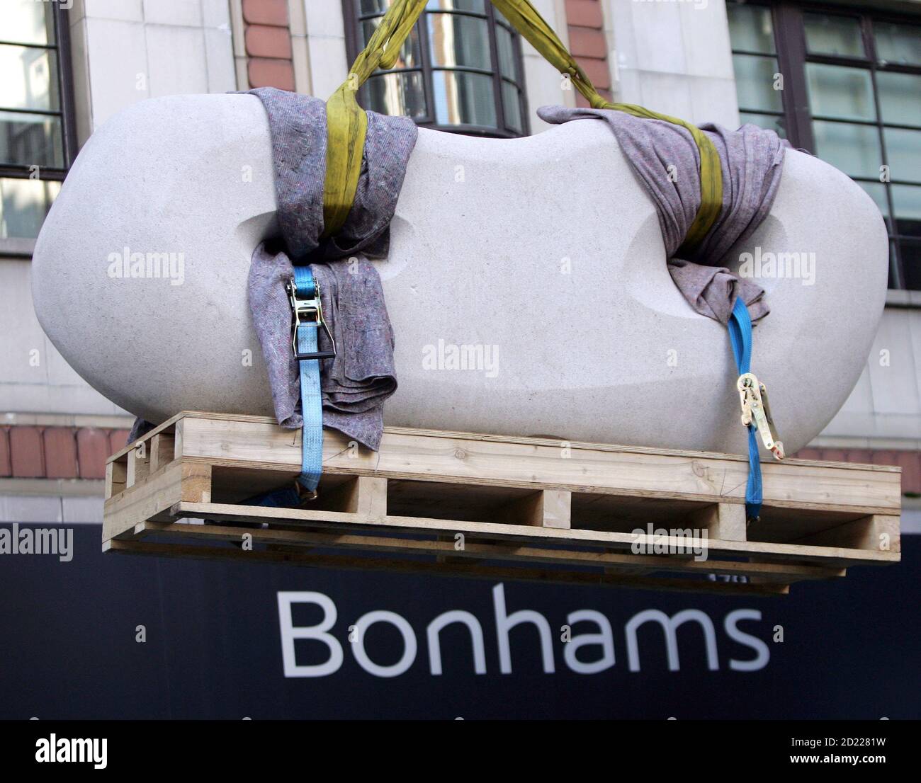A sculpture by artist Dame Barbara Hepworth entitled 'Curved Reclining Form (Rosewall)' is transported by crane to Bonhams auctioneers in London September 28, 2005. The sculpture, expected to fetch between 600,000 and 800,000 pounds ($1,060,260-1,413,680), is the highlight of Bonhams' 20th Century British Art sale to be held in November. REUTERS/Stephen Hird Stock Photo