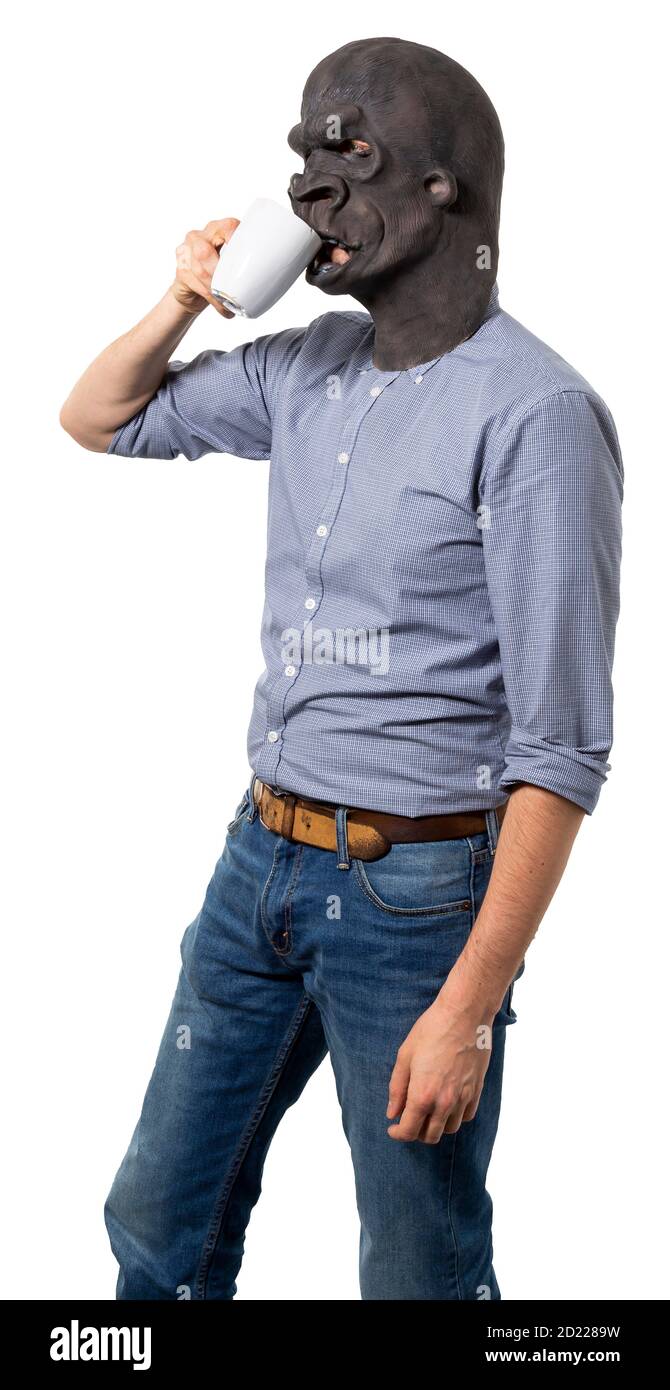 Man wearing gorilla mask drinking from porcelain cup. Profile view