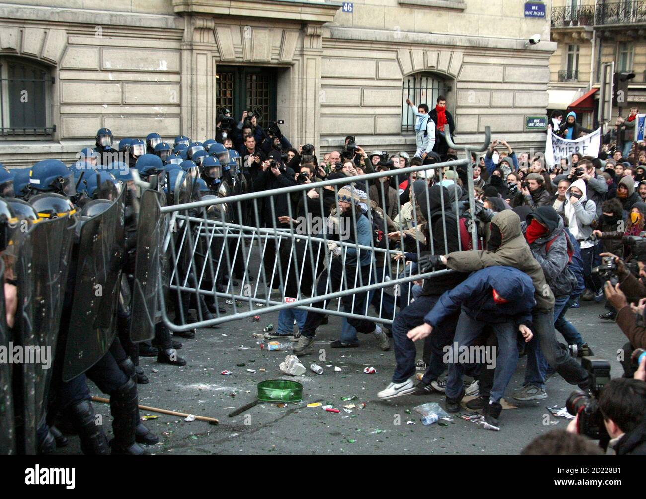 Hooded youths throw barricades at French riot police outside the Sorbonne  during a student demonstration in the Latin Quarter in Paris March 14,  2006. Students demonstrated to demand the withdrawal of the