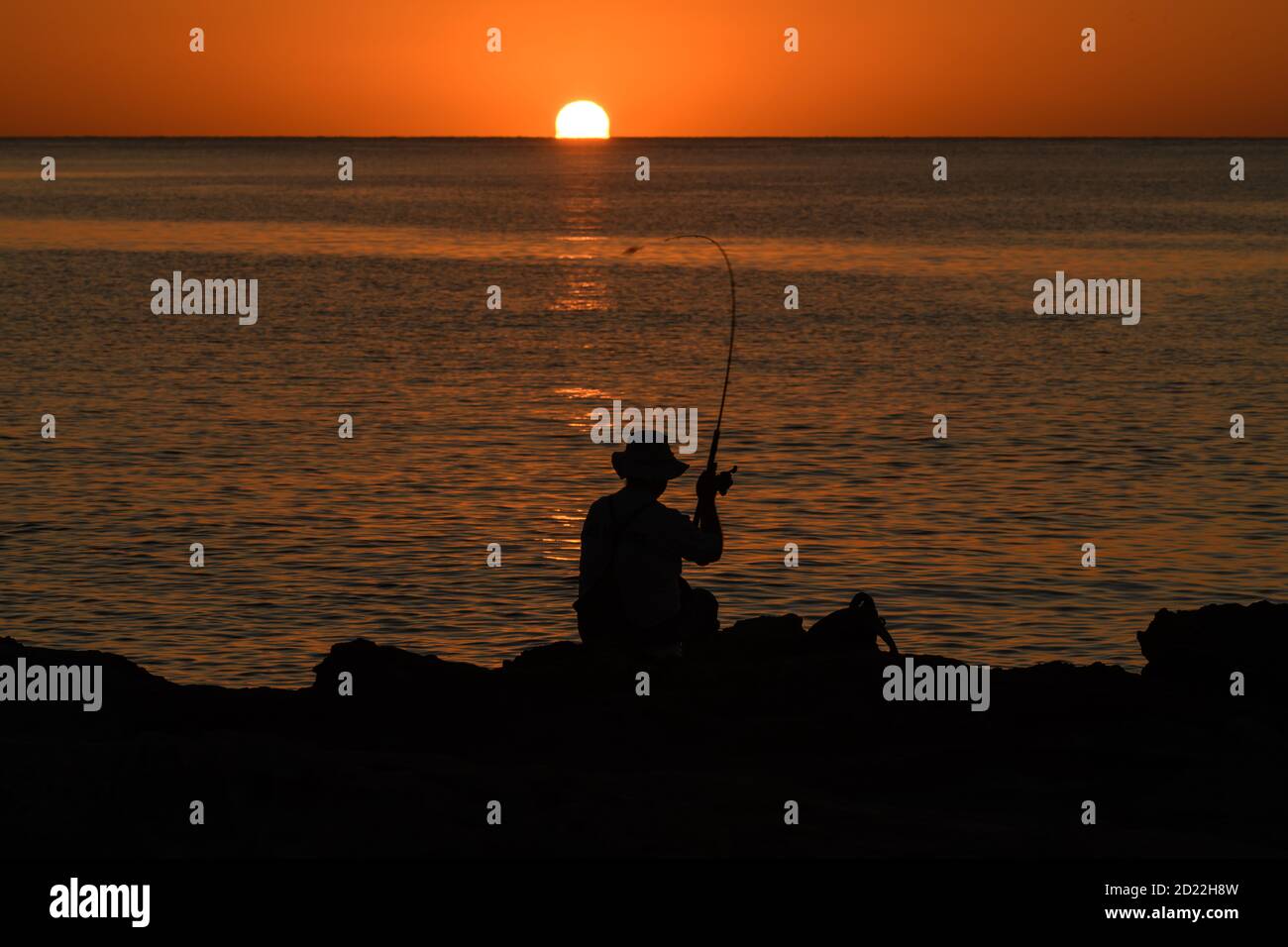 Mediterranean sunrise with a fisherman silhouette Stock Photo - Alamy