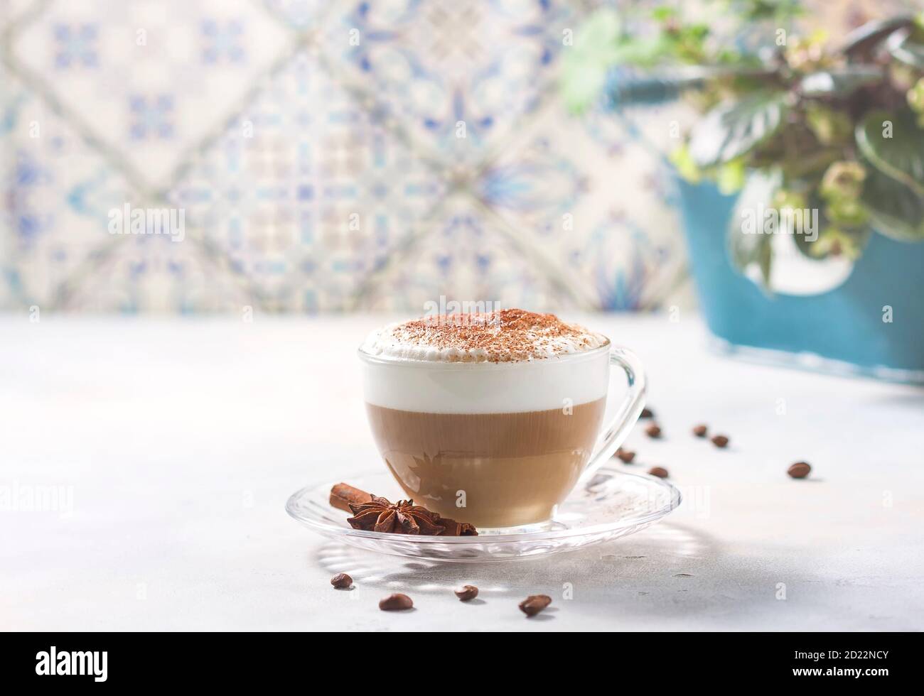 Cappuccino or latte in a glass cup on a light background. Stock Photo