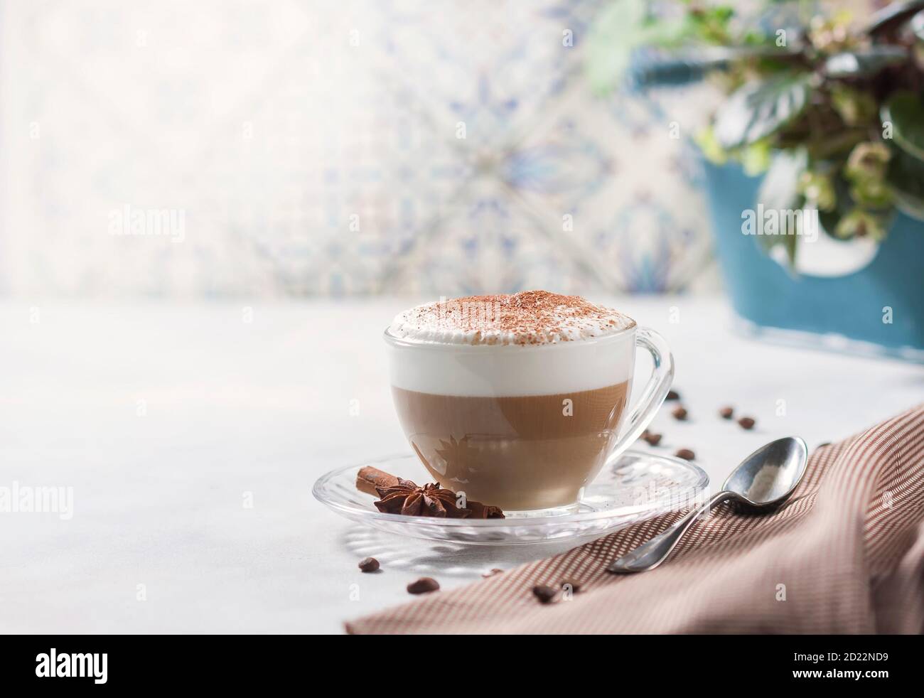 Cappuccino or latte in a glass cup on a light background. Stock Photo