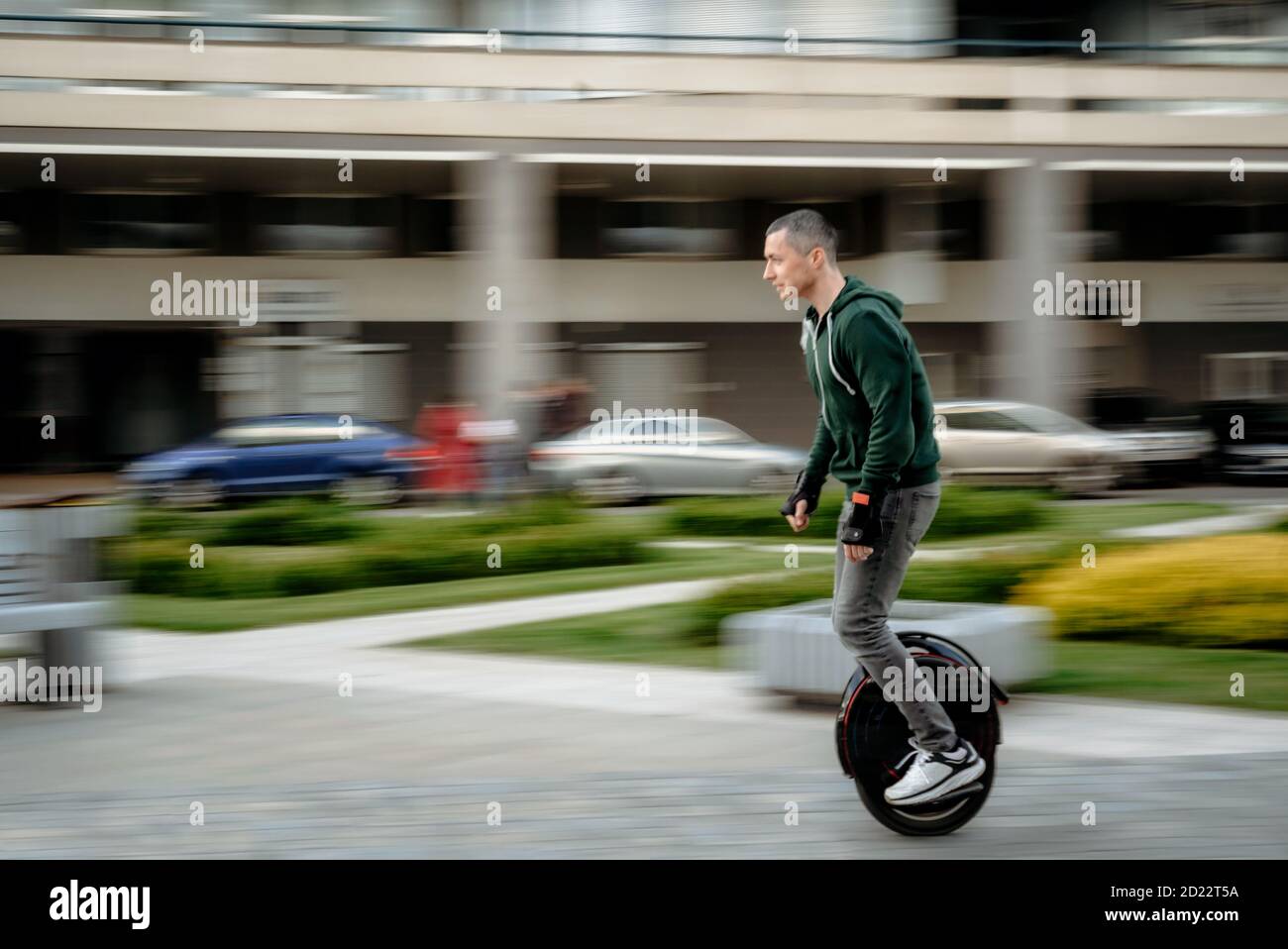 Man riding unicycle on street, electric unicycle, motion blur Stock Photo