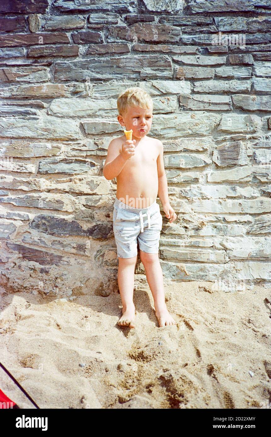 Three year old boy playing on Mouthwell beach, Hope Cove, Kingsbridge, Devon, England, United Kingdom. Stock Photo