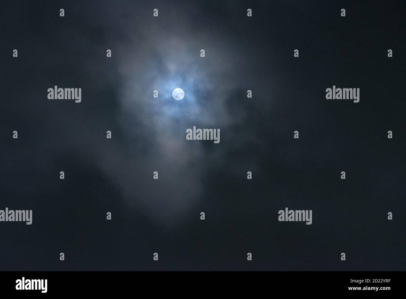Moon behind clouds Stock Photo Alamy