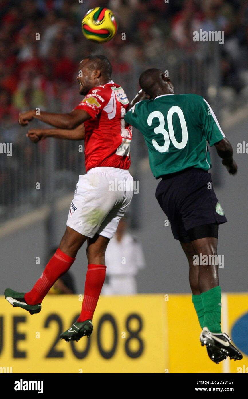 Al-Ahly's Flavio Amado (R) jumps for the ball with Coton Sport's Marcellin  Gaha Djiadeu during their African Champions League final soccer match in  Cairo November 2, 2008. REUTERS/Amr Dalsh (EGYPT Stock Photo -