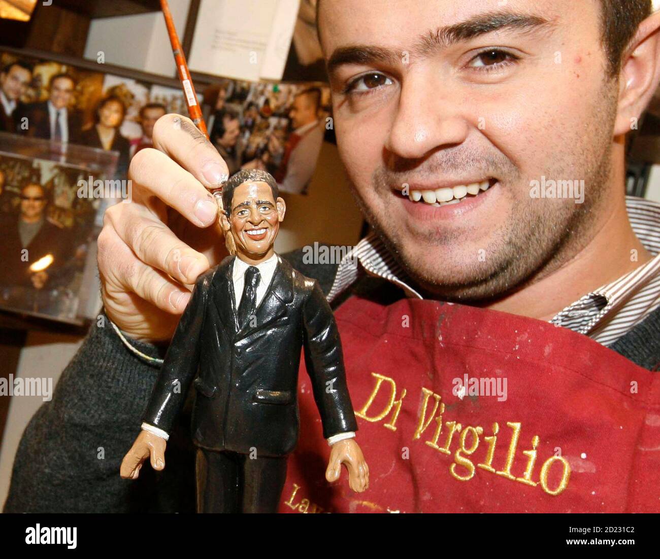 Craftsman Genny Di Virgilio holds a clay figure of U.S. President-elect Barack Obama, for use in Christmas nativity scenes, at his shop in Naples December 10, 2008. Obama and his wife Michelle are appearing in Italian nativity scenes this year, alongside the baby Jesus and wise men, according to Naples craftsmen selling figurines in the run-up to Christmas.     REUTERS/Ciro De Luca/Agnfoto   (ITALY) Stock Photo