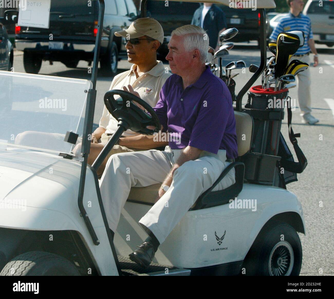 U.S. President Barack Obama (L) rides in a golf cart driven by Mike Thomas,  General Manager of the Andrews Air Force Base golf course, as they prepare  to play a round of