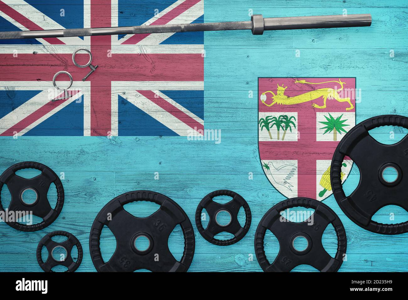 Fiji gym concept. Top view of heavy weight plates with iron bar on