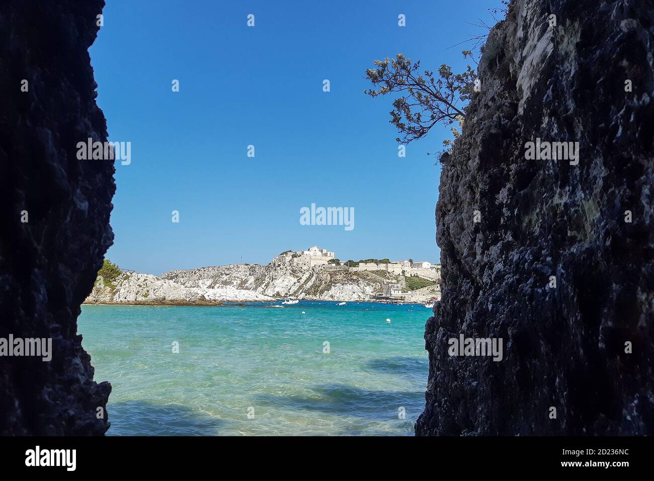View of San Nicola Island trought the rock of cala delle arene beach in San Domino island. Stock Photo