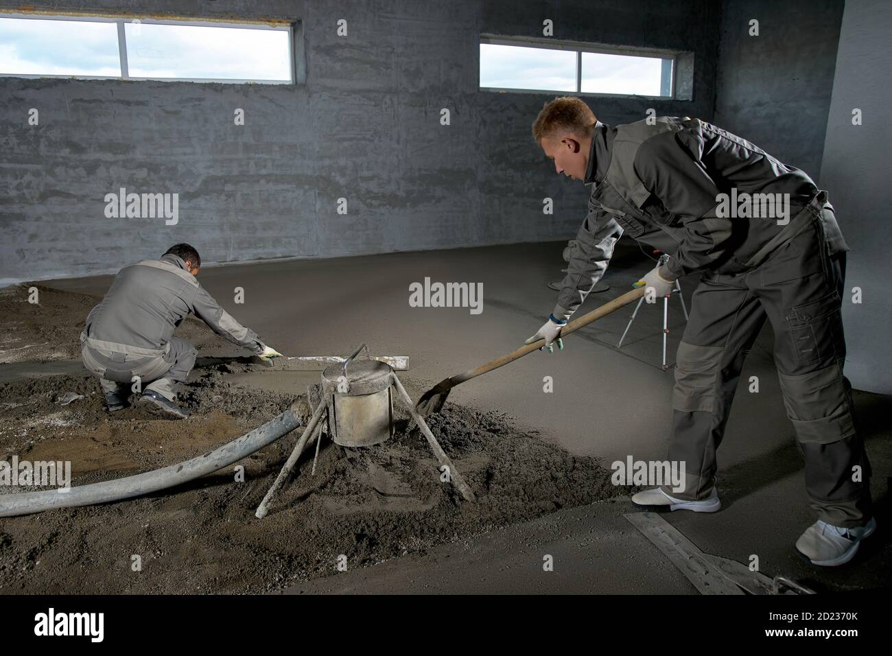 Filling the floor with concrete, screed and leveling the floor by ...
