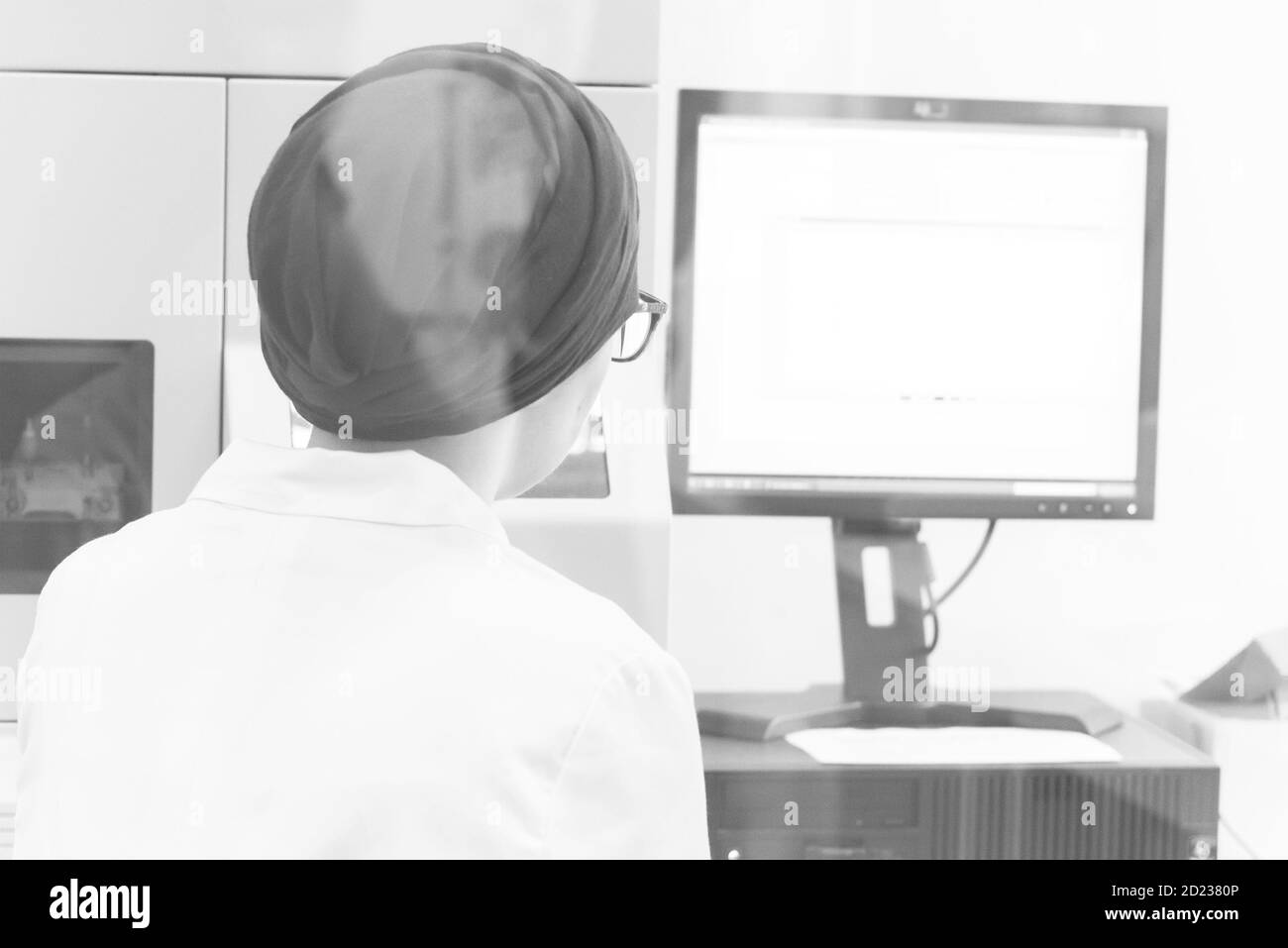 Young female Laboratory scientist working at lab with test tubes and microscope, test or research in clinical laboratory.Science, chemistry, biology, Stock Photo