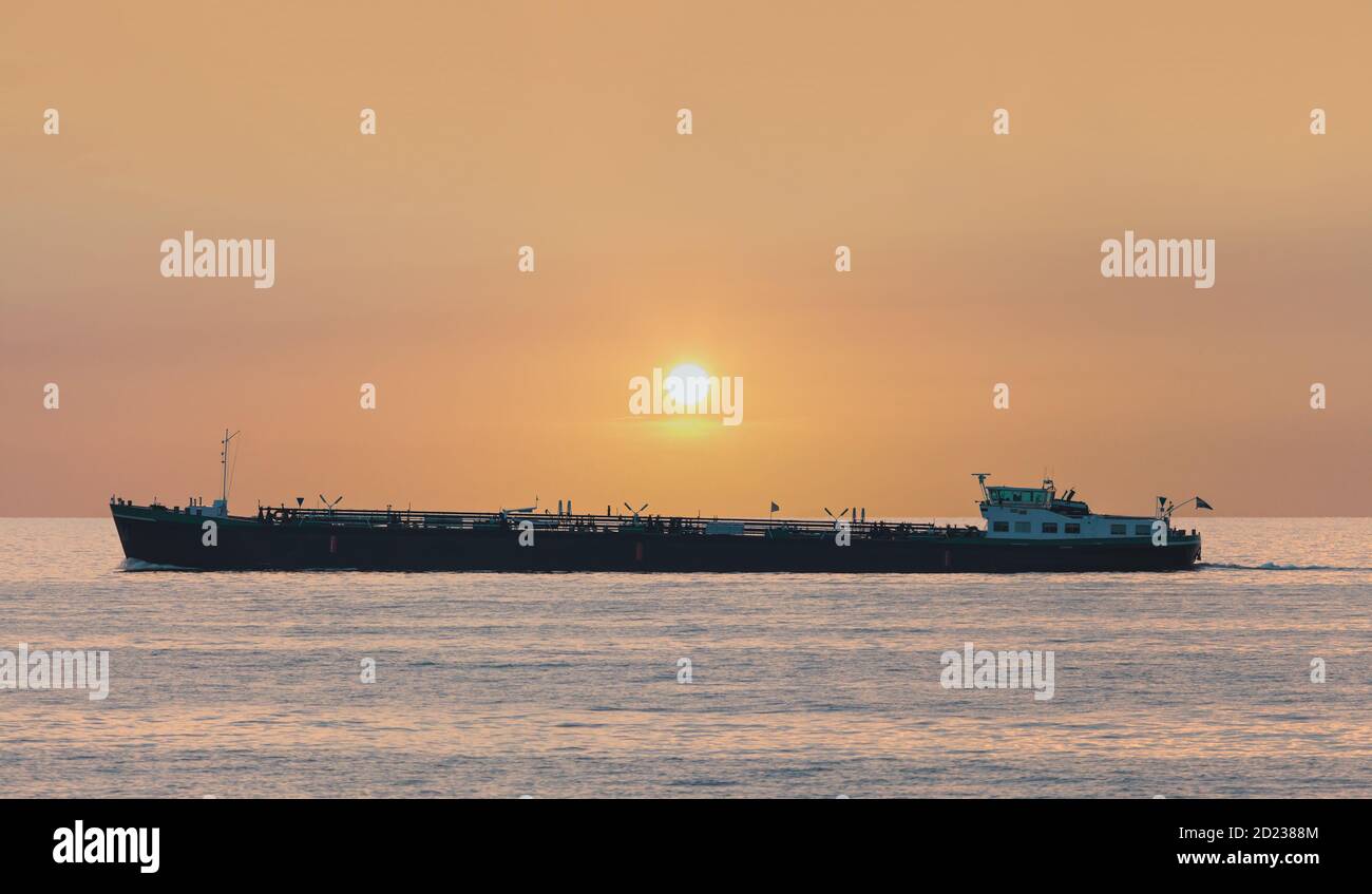 Freight ship passing The Markermeer lake in Holland during sunset Stock Photo