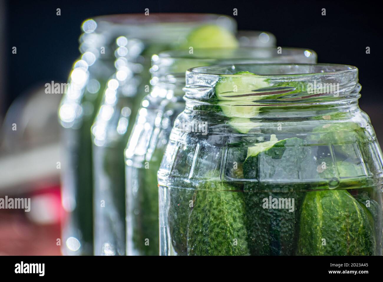 cucumbers in jars, the process of making pickled gherkins Stock Photo