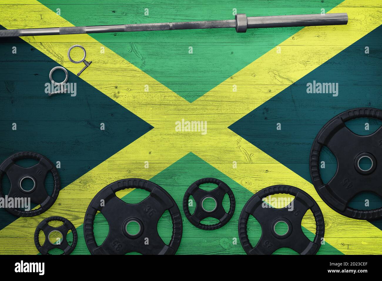 Jamaica gym concept. Top view of heavy weight plates with iron bar on