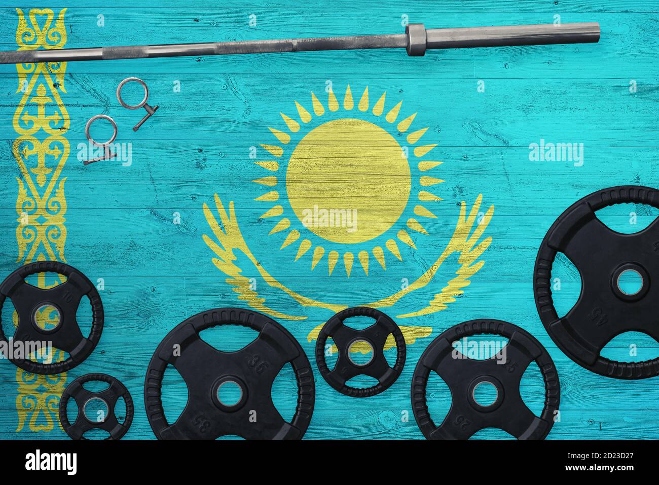 Kazakhstan gym concept. Top view of heavy weight plates with iron bar