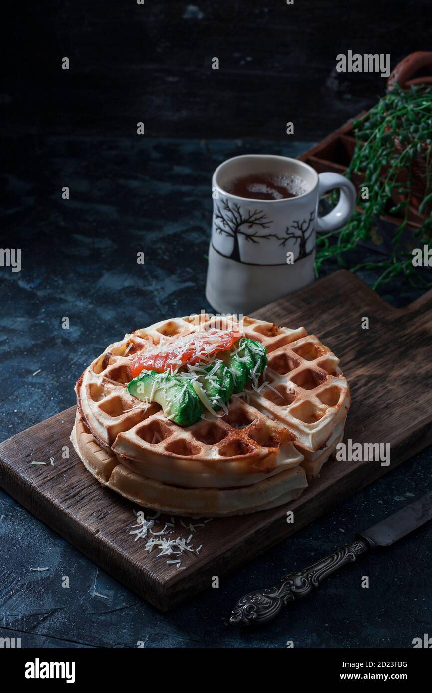 Cheese waffles with avocado, salted red fish for breakfast. An ideal breakfast for a healthy diet. Stock Photo