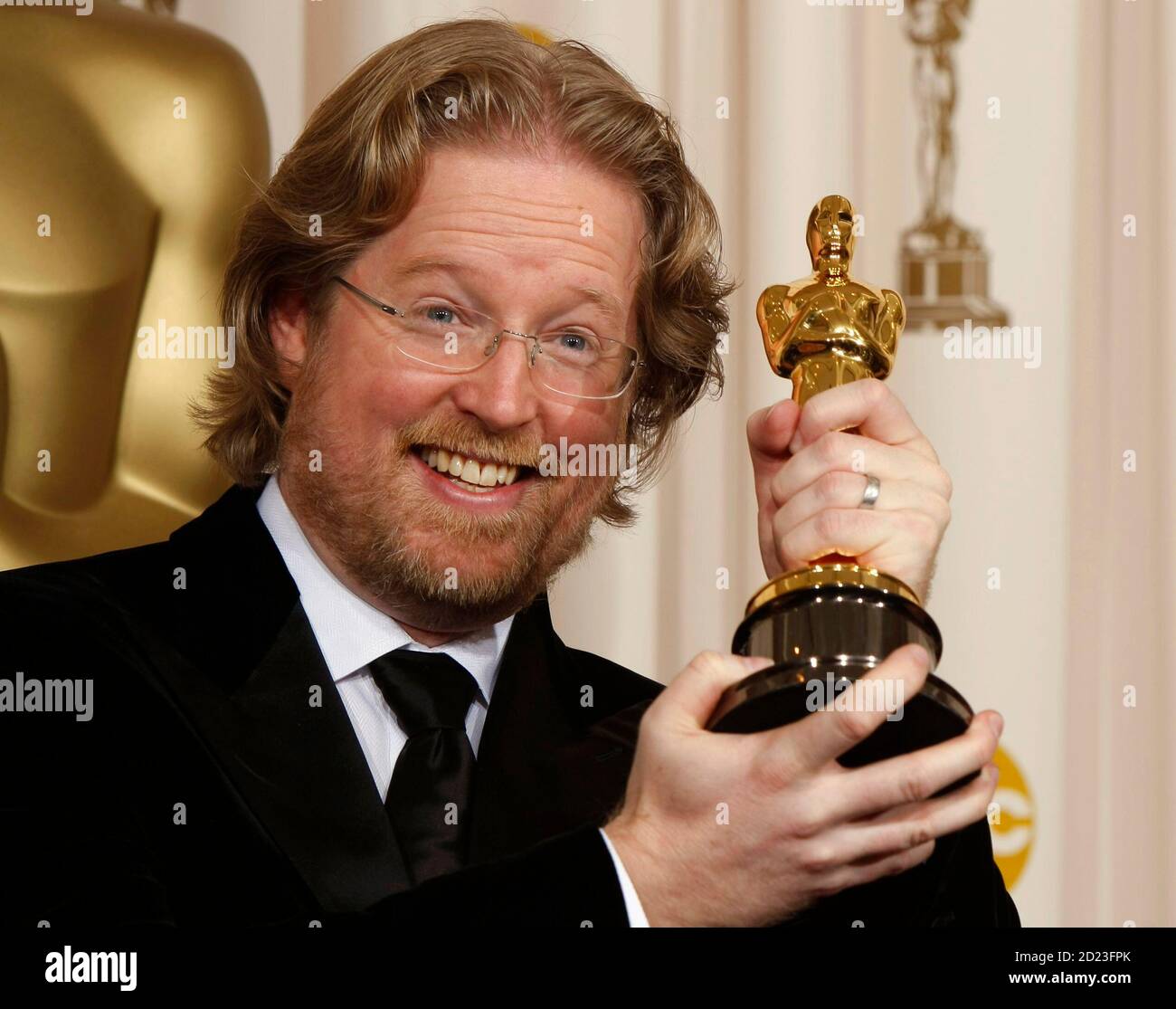 Andrew Stanton poses with his Oscar for best animated feature with the film  