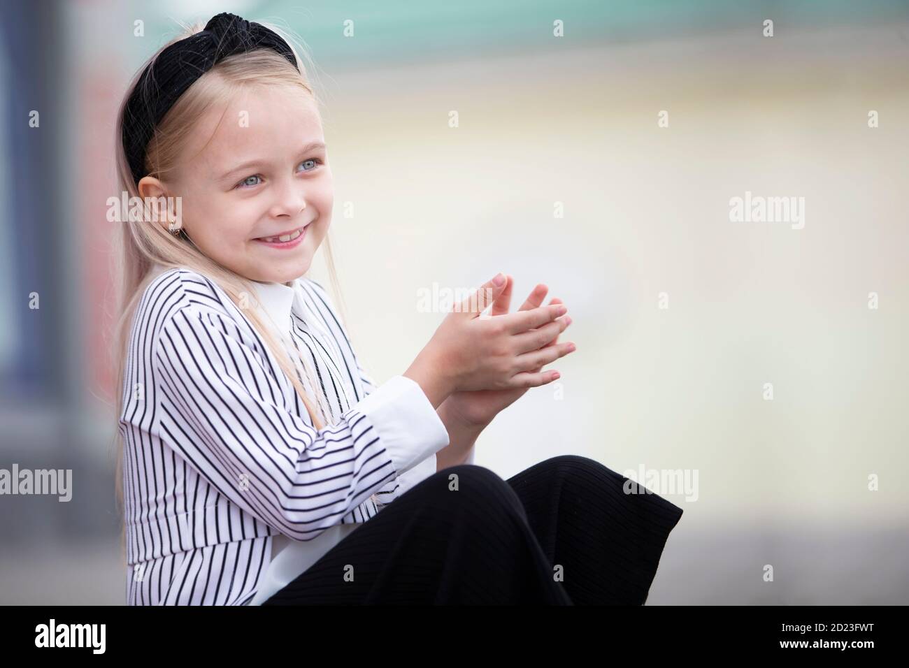 Portrait of a happy little girl with blond hair Stock Photo - Alamy