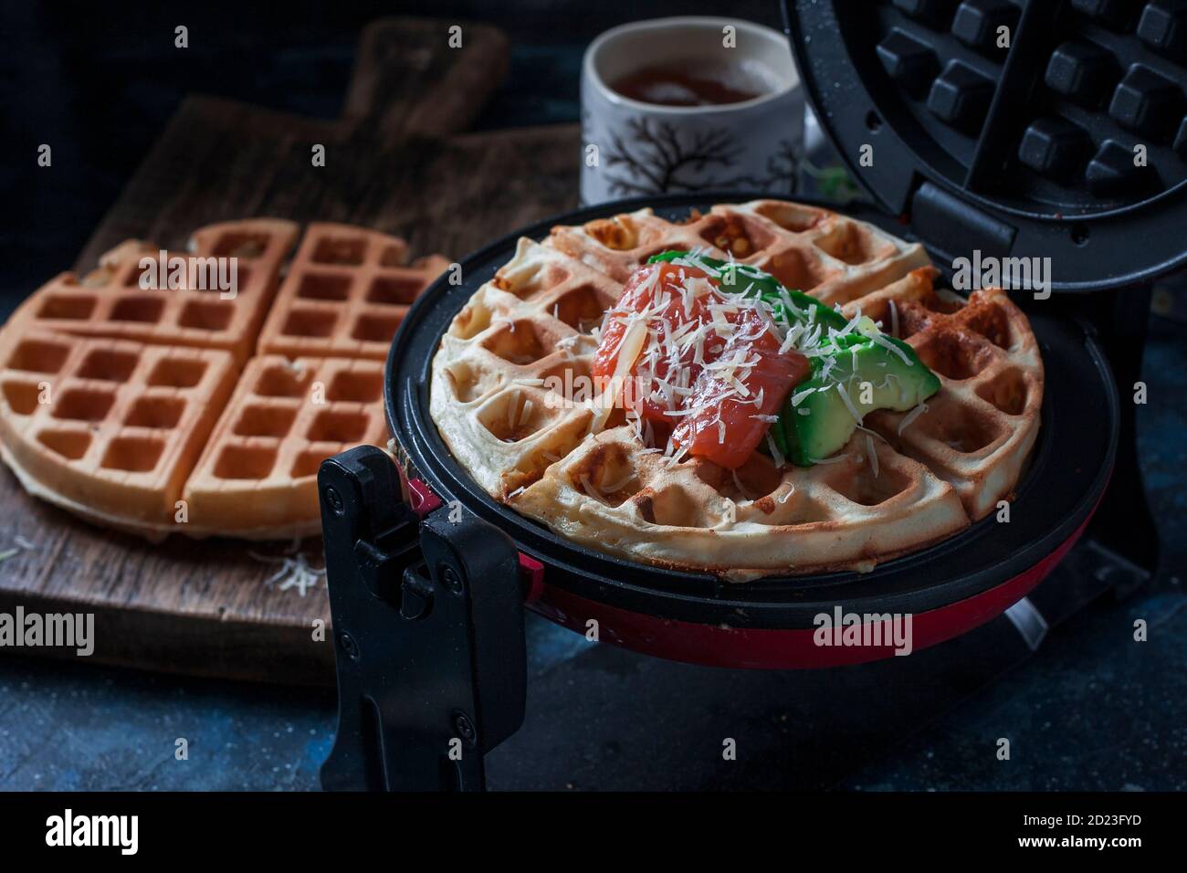 Cheese waffles with avocado, salted red fish for breakfast. An ideal breakfast for a healthy diet. Stock Photo