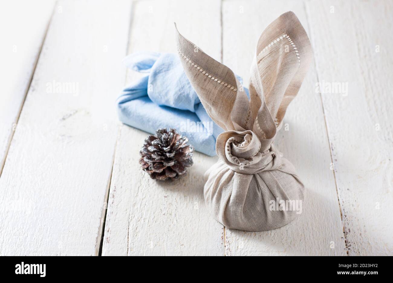 Furoshiki - traditional Japanese technique of wrapping tying items for gift. Zero waste gift wrapping. Stock Photo