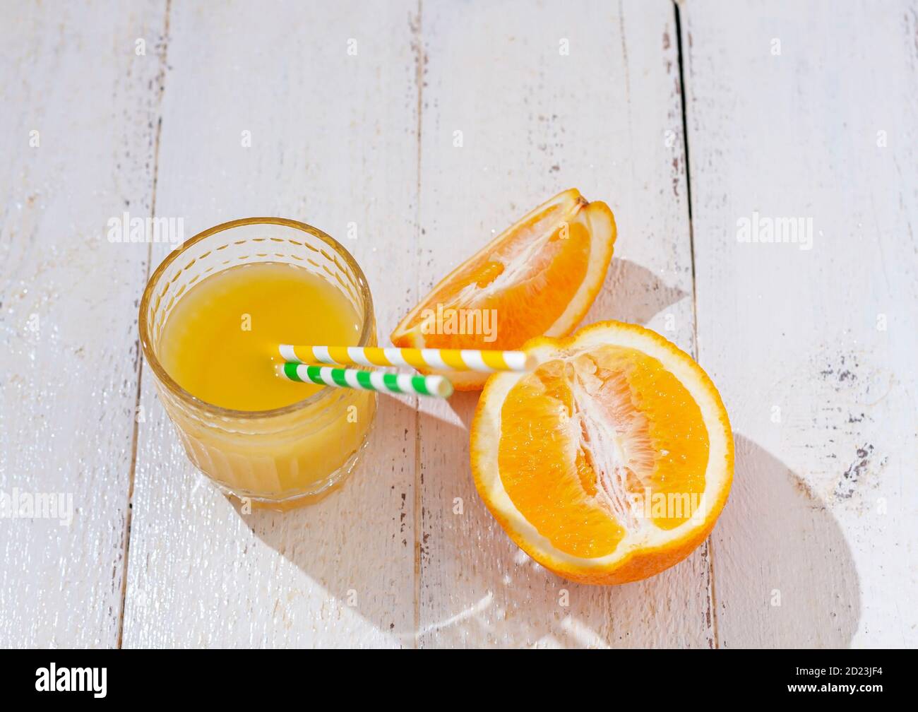 Glass of fresh orange juice and fresh orange on a white background. Healthy drink concept. Stock Photo