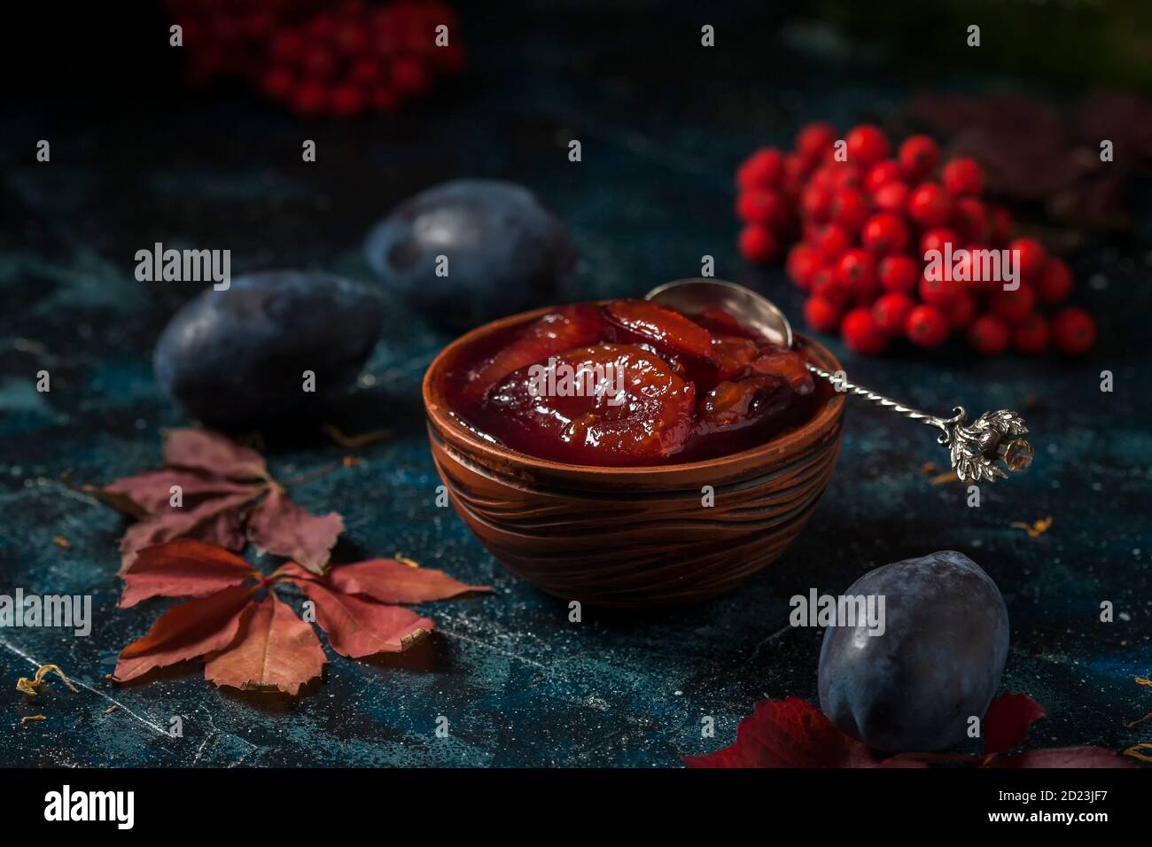 Homemade plum jam and fruits on a wooden table. Stock Photo