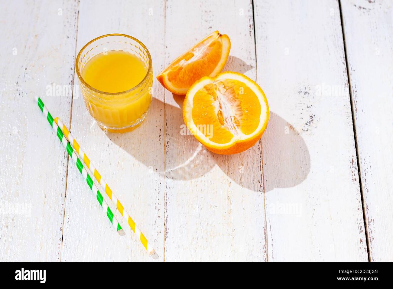 Glass of fresh orange juice and fresh orange on a white background. Healthy drink concept. Stock Photo