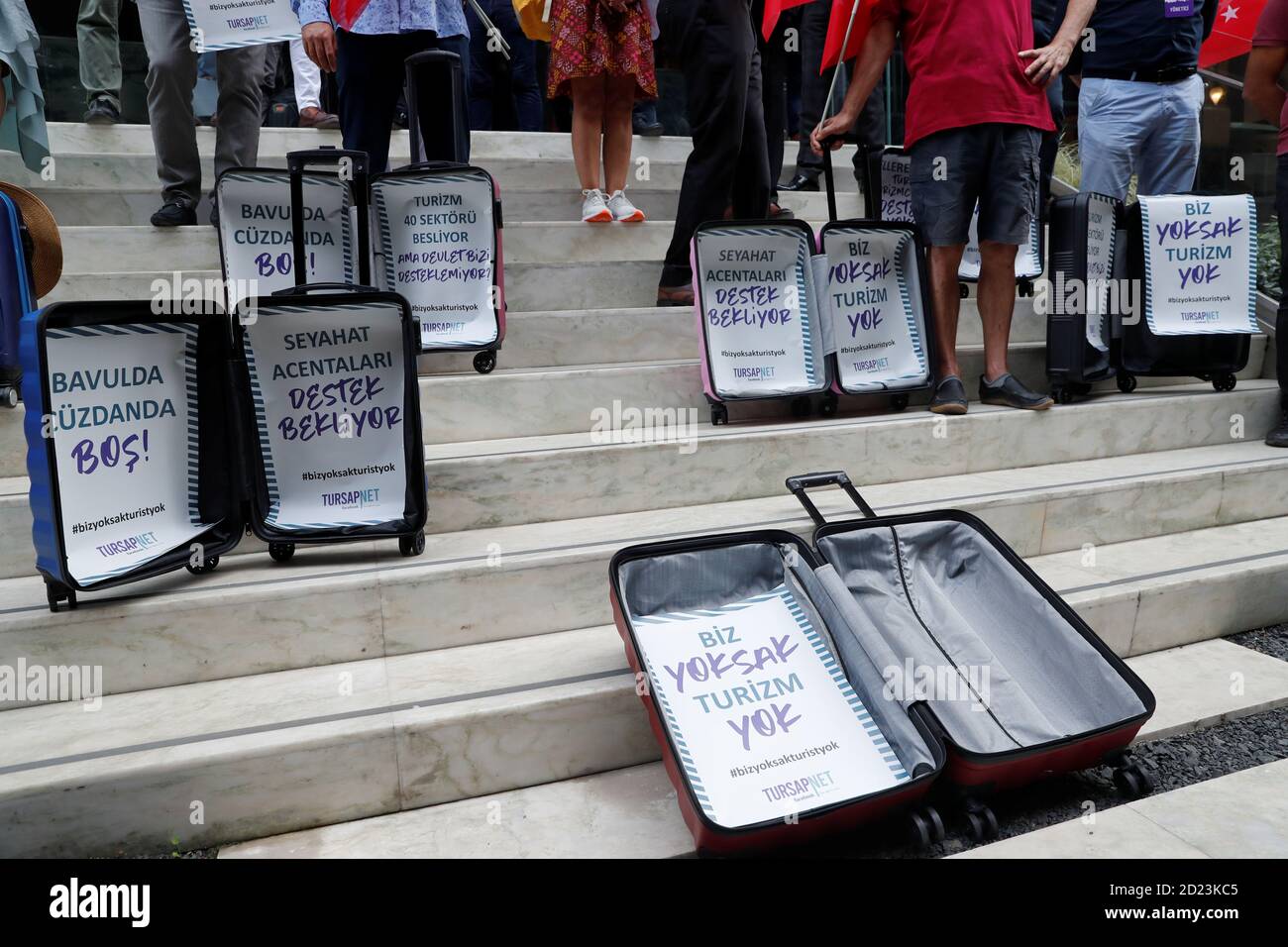 Travel agency owners display empty suitcases following a press statement demanding government's financial support for the tourism business as the spread of the coronavirus disease (COVID-19) continues, in Istanbul, Turkey October 6, 2020. The slogans in the suitcases read: 'Suitcase and wallet are empty!' and 'Travel agencies await support'. REUTERS/Murad Sezer Stock Photo