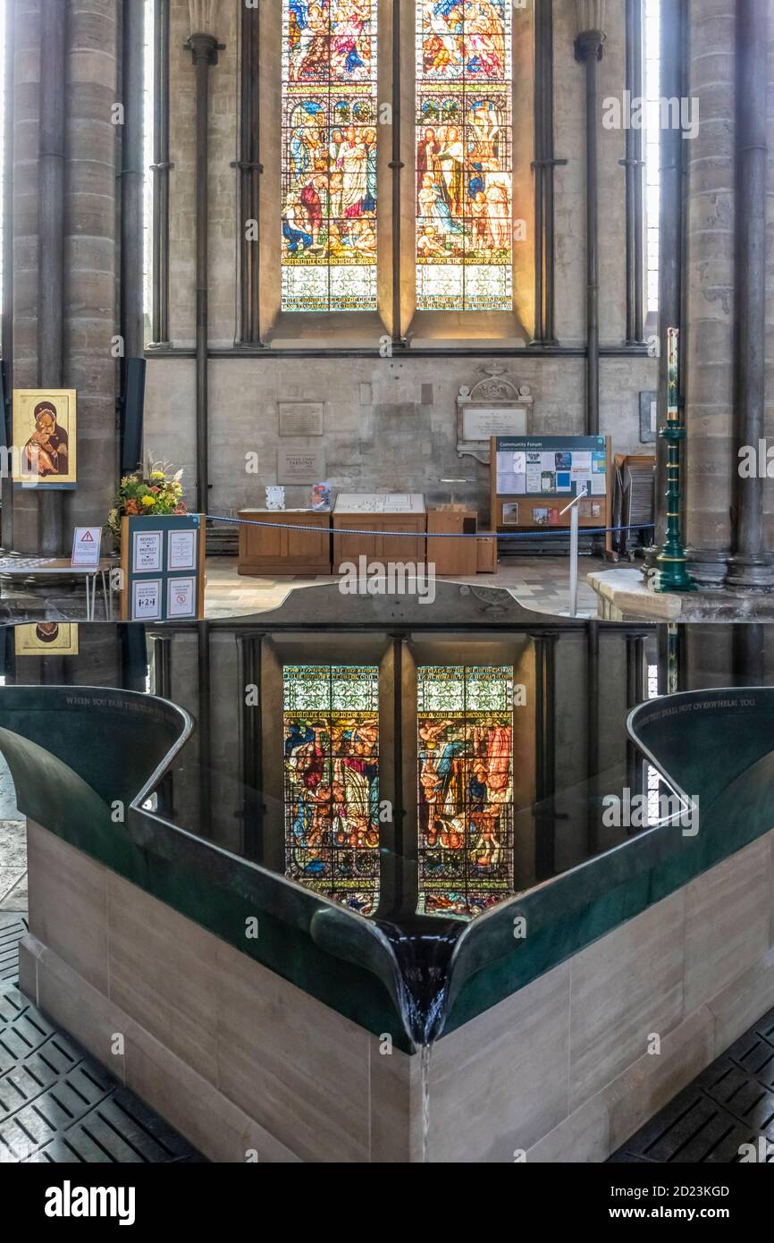The modern font and reflection of stained glass window, Salisbury Cathedral Stock Photo