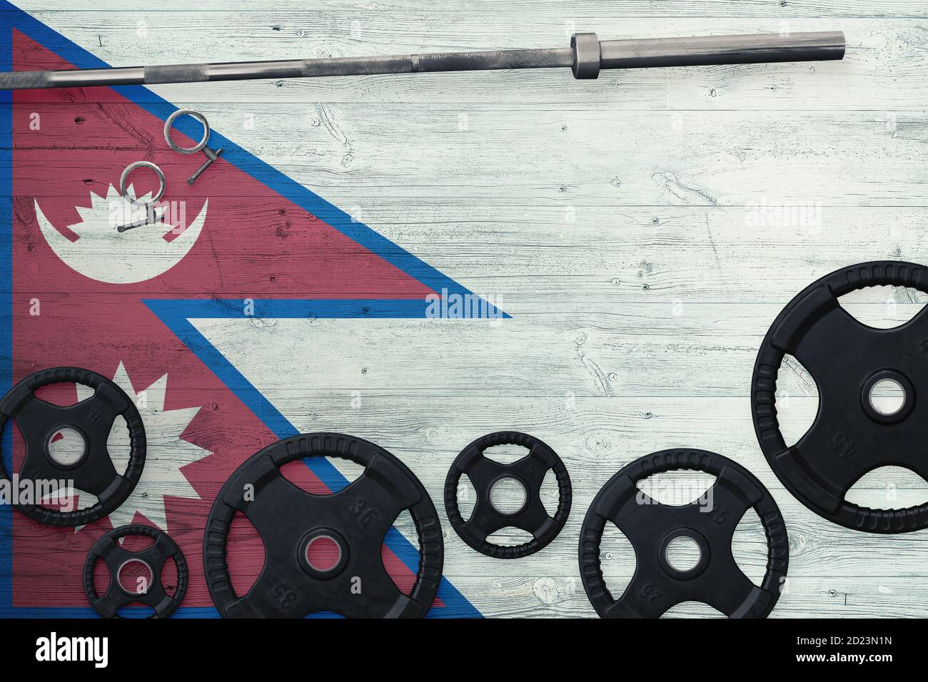 Nepal gym concept. Top view of heavy weight plates with iron bar on