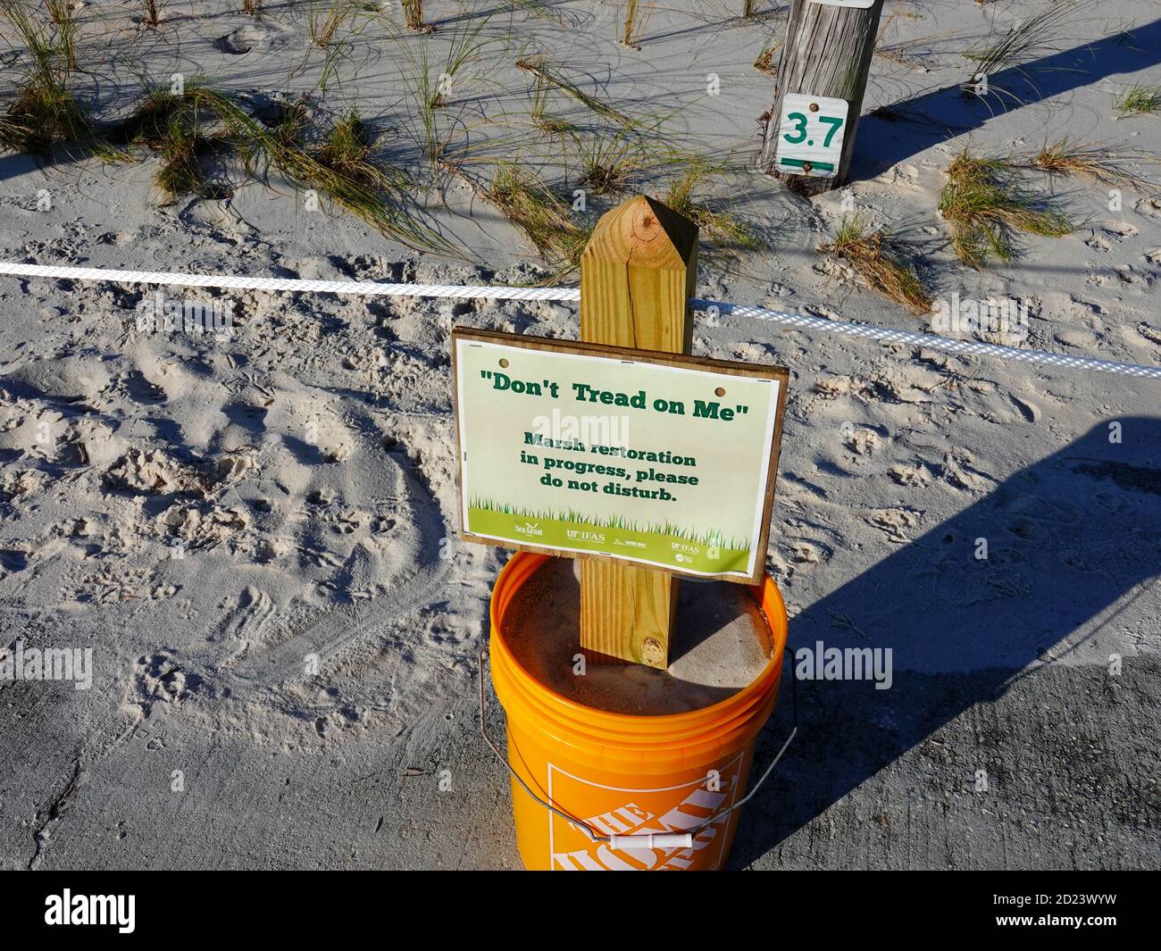 'Don’t tread on me,' sign at designated marsh restoration area where sea grass has been planted in an effort to restore the coastline, Cedar Key, Fla. Stock Photo