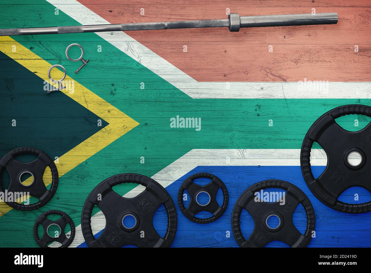 South Africa gym concept. Top view of heavy weight plates with iron bar