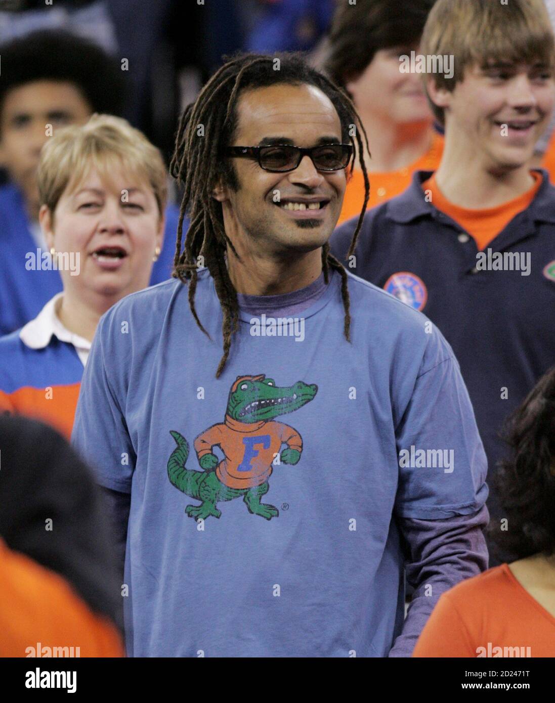 French tennis player Yannick Noah (C) watches his son, Florida Gators'  [Joakim Noah] during team warm-ups before the start of the championship  basketball game at the men's NCAA Final Four in Indianapolis
