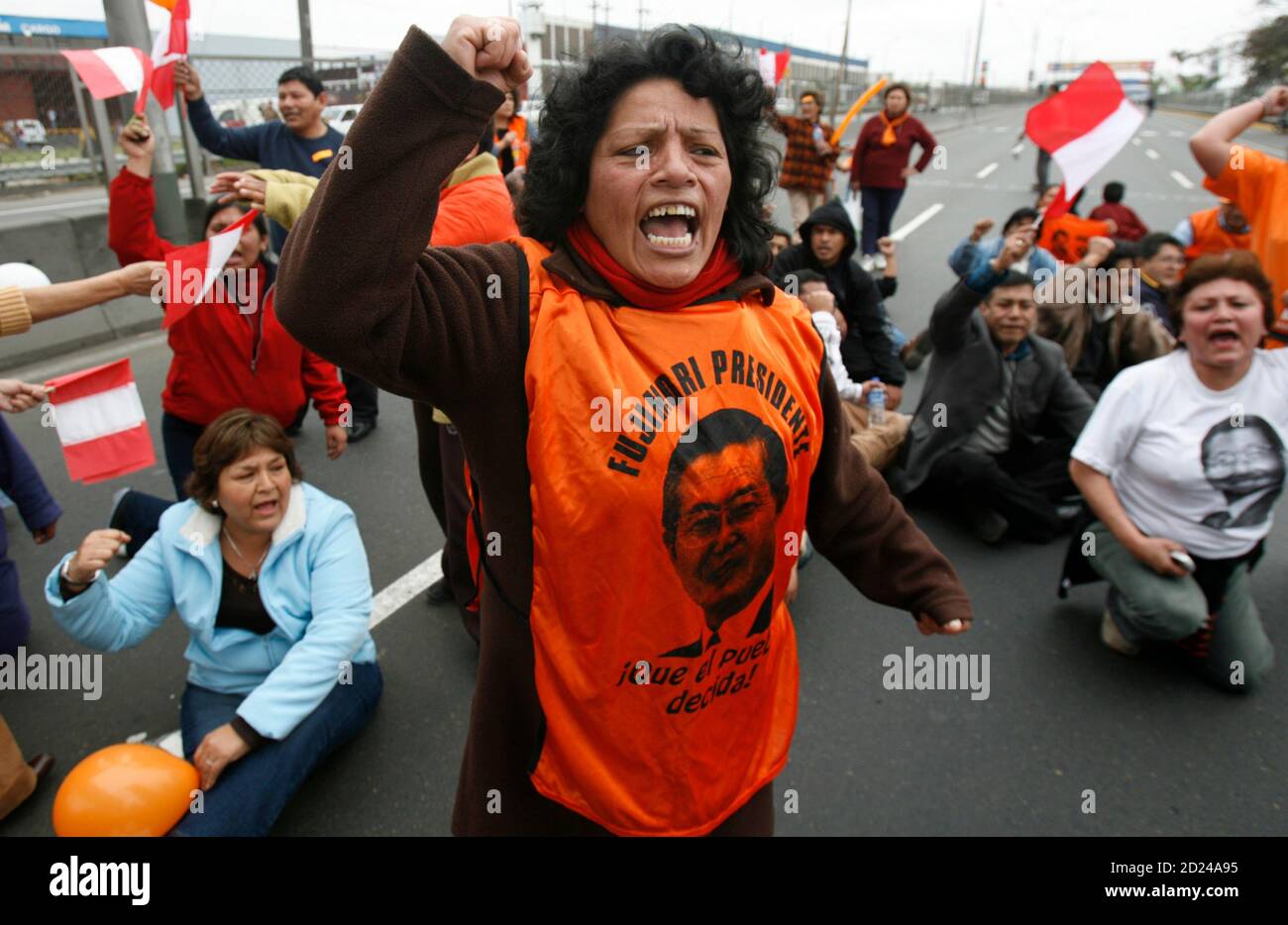 Supporters of Peru's former President Alberto Fujimori protest outside the airport before his arrival in Lima September 22, 2007. Fujimori was flown out of Chile on Saturday to face charges of human rights abuse and corruption seven years after fleeing Peru for Japan. REUTERS/Mariana Bazo (PERU) Stock Photo