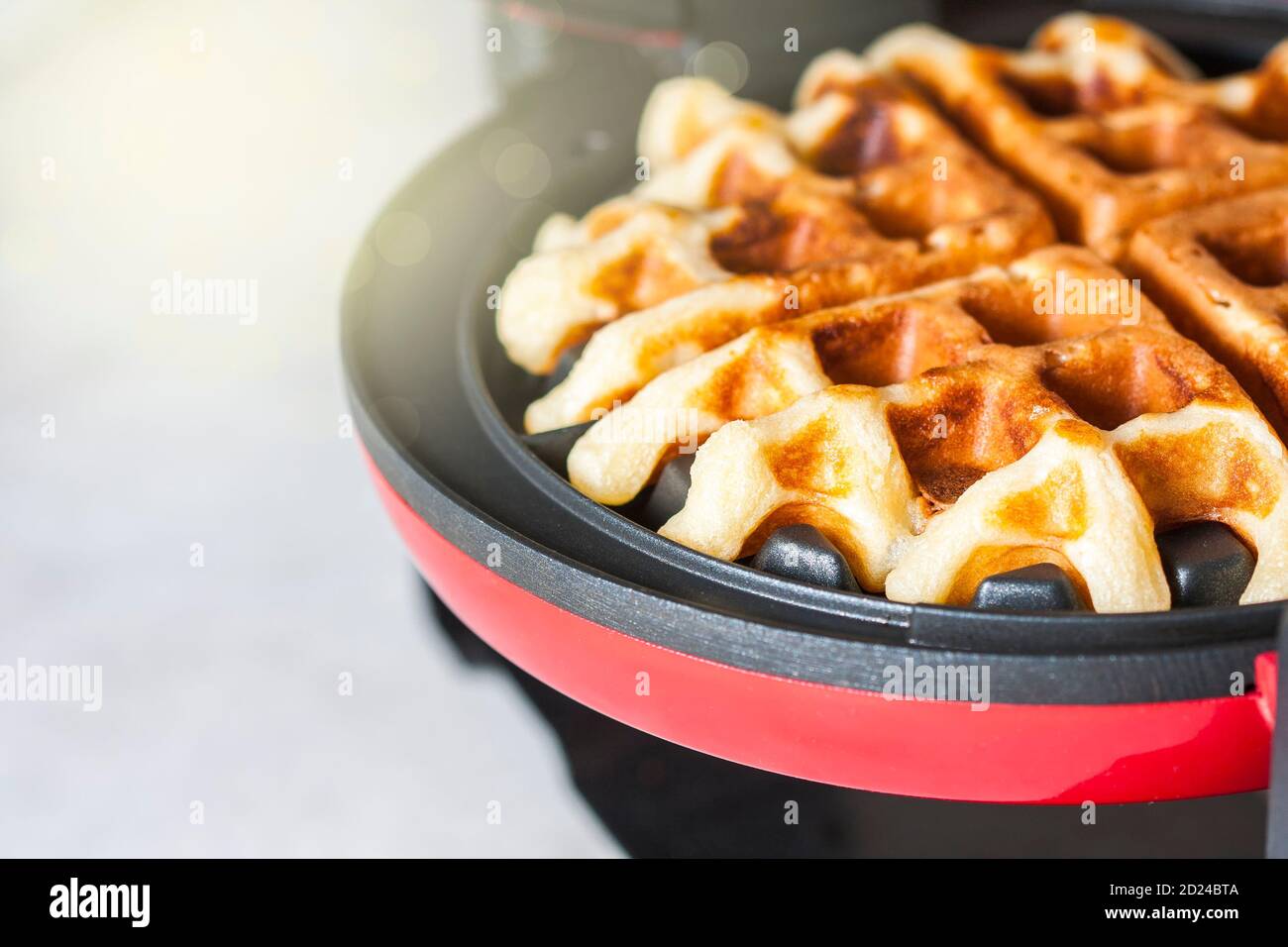 The process of making homemade waffles. Freshly baked waffles in a
