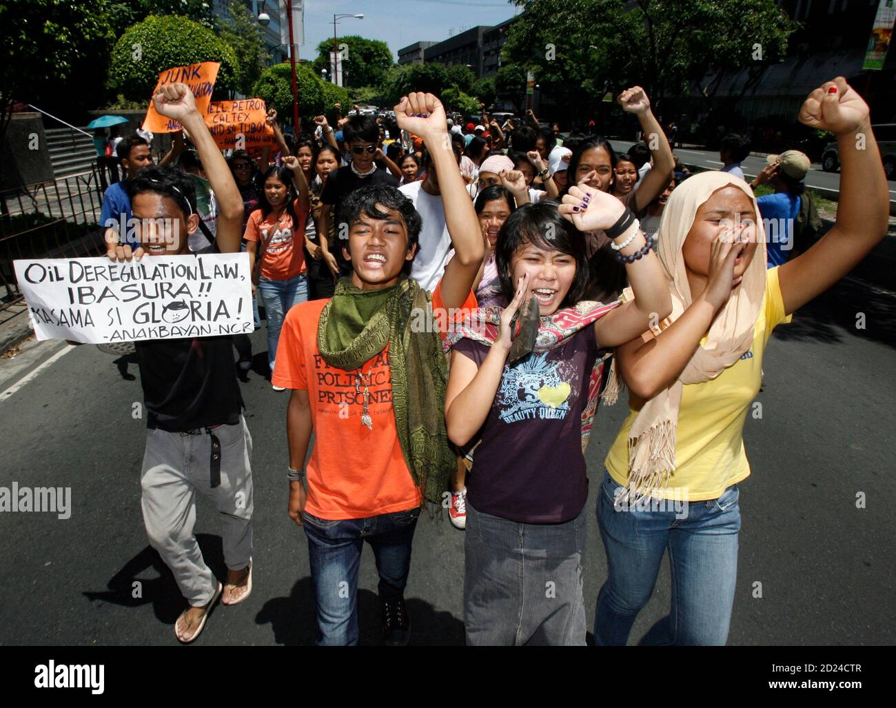 Protesters clench fists after holding a protest in front of Petron oil  company's head office in Makati's financial district of Manila July 11,  2008. The protesters on Friday appealed to the government