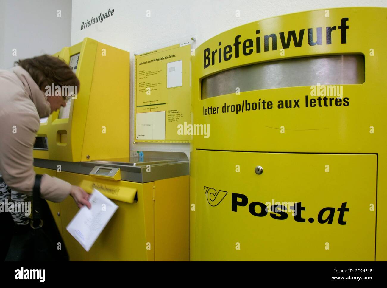 A woman drops a letter in a post office in Vienna November 12, 2008.  Austria's Infrastructure Minister Werner Faymann said on Tuesday he aims to  delay the closure of branches run by